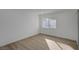 Well-lit bedroom with wood-look flooring and large window at 4419 Fairmont Cir, Las Vegas, NV 89147