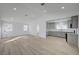 Open-concept living room and kitchen with wood-look flooring and recessed lighting at 4419 Fairmont Cir, Las Vegas, NV 89147