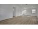Spacious living room featuring laminate flooring, white walls, and natural light at 4419 Fairmont Cir, Las Vegas, NV 89147