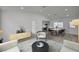 Bright living room and dining area featuring modern furnishings, neutral color palettes, and sleek laminate flooring at 4419 Fairmont Cir, Las Vegas, NV 89147