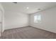 Neutral bedroom with carpeted floor and a window, offering ample natural light at 4928 Canna Lily St, Las Vegas, NV 89122