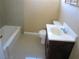 Full bathroom with a shower-tub combo, a vanity with a solid surface counter, and tiled flooring offering functional design at 500 S 13Th St # C6, Las Vegas, NV 89101