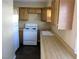 Functional kitchen with white appliances, light wood cabinets, and tile flooring offering practical design at 500 S 13Th St # C6, Las Vegas, NV 89101