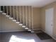 Entryway with a view of the staircase featuring white railing and front door, bathed in natural light at 500 S 13Th St # C6, Las Vegas, NV 89101