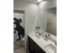 Bathroom with dual sinks, vanity, and a dinosaur themed shower curtain at 5404 Scandia Lore Ct, Las Vegas, NV 89130
