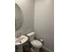 Powder room featuring a pedestal sink, toilet, and neutral wall paint at 5404 Scandia Lore Ct, Las Vegas, NV 89130