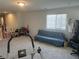 Open carpeted bonus room featuring a futon, exercise equipment, and trophies on display at 5404 Scandia Lore Ct, Las Vegas, NV 89130