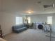 Spacious bonus room with carpet flooring, featuring a futon and exercise equipment at 5404 Scandia Lore Ct, Las Vegas, NV 89130