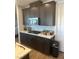 Kitchen with modern appliances, dark wood cabinets, and stone countertops at 5404 Scandia Lore Ct, Las Vegas, NV 89130
