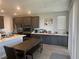 Eat in kitchen features dark wood cabinets, stainless appliances, and laminate floors at 5404 Scandia Lore Ct, Las Vegas, NV 89130