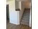 Carpeted staircase with white risers and stringers, complemented by light wood flooring at 5404 Scandia Lore Ct, Las Vegas, NV 89130