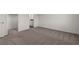 Well-lit bedroom with new carpet leading to a closet and the en-suite bathroom at 6234 Blood Lily Ave, Las Vegas, NV 89122