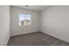 Cozy bedroom with neutral carpet, window view and natural light at 6234 Blood Lily Ave, Las Vegas, NV 89122
