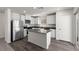 Modern kitchen with white cabinets, stainless steel appliances, and a gray countertop island, offering a clean aesthetic at 6234 Blood Lily Ave, Las Vegas, NV 89122