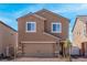 Charming two-story home features a covered front porch and a two-car garage at 6245 Blood Lily Ave, Las Vegas, NV 89122