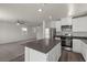 Open-concept kitchen features stainless steel appliances and a center island at 6245 Blood Lily Ave, Las Vegas, NV 89122