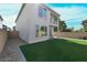 Home's backyard is landscaped with gravel, grass, patio and a balcony at 63 Harrison Rose Ct, Las Vegas, NV 89110