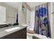 Charming bathroom with a floral shower curtain, sleek sink, and coordinated decor at 63 Harrison Rose Ct, Las Vegas, NV 89110
