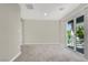 Bright bedroom with sliding glass doors to balcony and neutral carpet at 63 Harrison Rose Ct, Las Vegas, NV 89110