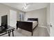 Cozy bedroom with a comfortable bed, neutral carpet, and a ceiling fan at 63 Harrison Rose Ct, Las Vegas, NV 89110