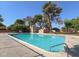 Well-kept community pool with a metal handrail for easy access, surrounded by greenery at 63 Harrison Rose Ct, Las Vegas, NV 89110