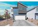 Modern two-story home boasts a two-car garage, contemporary design and desert landscaping at 63 Harrison Rose Ct, Las Vegas, NV 89110