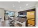 Modern kitchen features a large island, dark cabinetry, and a bright yellow refrigerator at 63 Harrison Rose Ct, Las Vegas, NV 89110