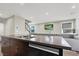 Open concept kitchen featuring a stainless steel double sink and dark cabinets at 63 Harrison Rose Ct, Las Vegas, NV 89110