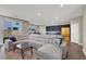 Open-concept living room features a plush sectional sofa and seamless flow into the kitchen at 63 Harrison Rose Ct, Las Vegas, NV 89110