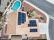 Aerial view of home with solar panels, a private pool, desert landscaping, and a spacious driveway at 6328 Yankee Meadow Cir, Las Vegas, NV 89130