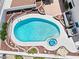 Aerial view of a backyard pool and spa with cool blue water, complete with patio furniture at 6328 Yankee Meadow Cir, Las Vegas, NV 89130