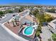 Aerial shot featuring a house with solar panels, pool, desert landscape, and mountain views at 6328 Yankee Meadow Cir, Las Vegas, NV 89130
