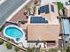 Aerial view showcasing a private pool, solar panels, tiled roof, and desert landscaping at 6328 Yankee Meadow Cir, Las Vegas, NV 89130