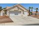 Single-story home boasting a spacious driveway, two-car garage, and low-maintenance desert landscaping at 6328 Yankee Meadow Cir, Las Vegas, NV 89130