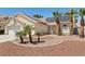 Inviting single-story home featuring solar panels, desert landscaping with palm trees, and a two-car garage at 6328 Yankee Meadow Cir, Las Vegas, NV 89130