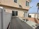 Backyard deck and patio with sliding glass doors and a view of the home's stucco exterior at 6459 Rusticated Stone Ave # 103, Henderson, NV 89011