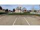 Community basketball court with hoop and white fencing in a common area at 6459 Rusticated Stone Ave # 103, Henderson, NV 89011