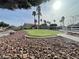 Well-kept community green space with palm trees and decorative rock landscaping at 6459 Rusticated Stone Ave # 103, Henderson, NV 89011
