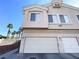 Two-story home with a two-car garage and neutral stucco exterior at 6459 Rusticated Stone Ave # 103, Henderson, NV 89011