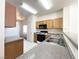 Well-lit kitchen featuring wood cabinets and modern appliances at 6459 Rusticated Stone Ave # 103, Henderson, NV 89011