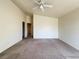 Spacious carpeted bedroom with ceiling fan and access to ensuite at 6459 Rusticated Stone Ave # 103, Henderson, NV 89011