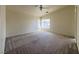 Large main bedroom with carpet, bright windows, and ceiling fan at 6459 Rusticated Stone Ave # 103, Henderson, NV 89011
