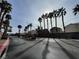 Serene neighborhood street adorned with palm trees, leading to community entrance at 6459 Rusticated Stone Ave # 103, Henderson, NV 89011