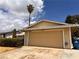 Attached two-car garage with palm tree in the yard adds to the home's curb appeal at 6460 Linda Ln, Las Vegas, NV 89103