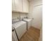 Convenient laundry room with washer, dryer, and ample cabinet space at 6460 Linda Ln, Las Vegas, NV 89103