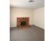 Cozy living room features a classic brick fireplace and updated carpet flooring at 6460 Linda Ln, Las Vegas, NV 89103