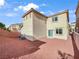 Spacious backyard with gravel landscaping and a home exterior in neutral colors at 6537 Ditmars St, Las Vegas, NV 89166