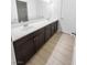 Spacious bathroom featuring double sink vanity with dark wood cabinetry and modern fixtures at 6537 Ditmars St, Las Vegas, NV 89166