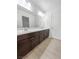 Spacious bathroom featuring double sink vanity with dark wood cabinetry and modern fixtures at 6537 Ditmars St, Las Vegas, NV 89166