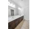 Spacious bathroom featuring double sink vanity with dark wood cabinetry and modern fixtures at 6537 Ditmars St, Las Vegas, NV 89166